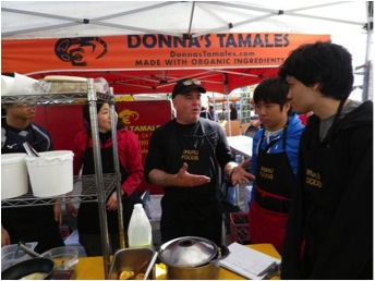 volunteer at farmers' market in Oakland